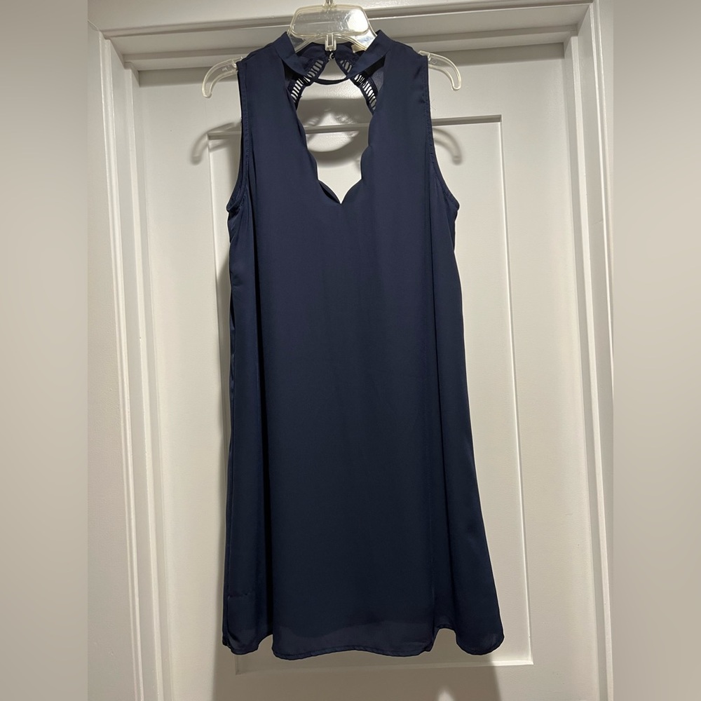 Navy blue dress with open high neck detail and double button closure